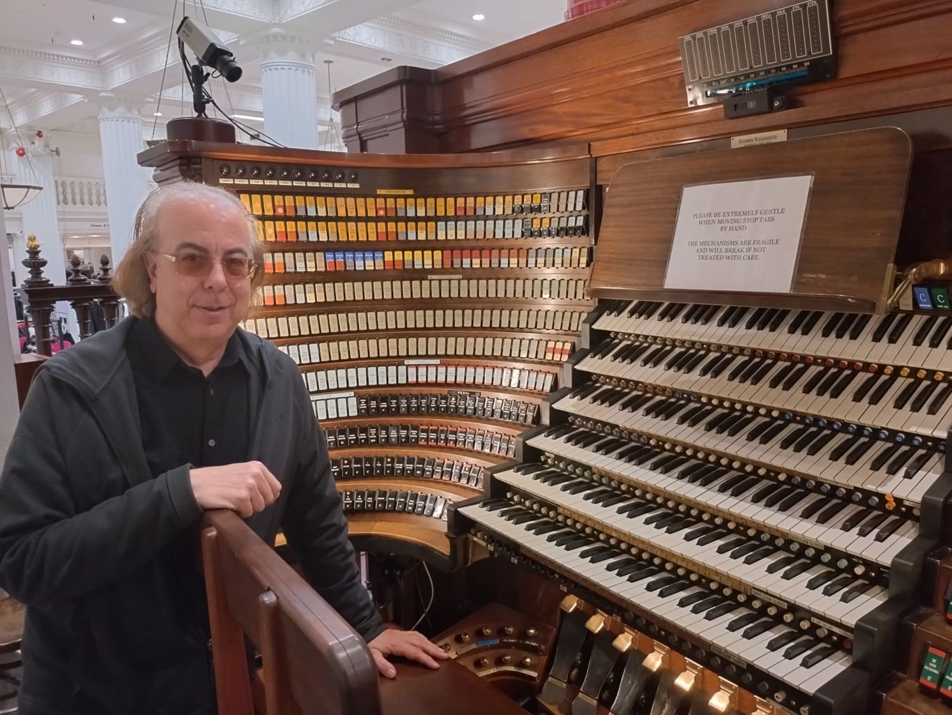 Picture of Peter Richard Conte by the console of the Wanamaker Grand Court Organ