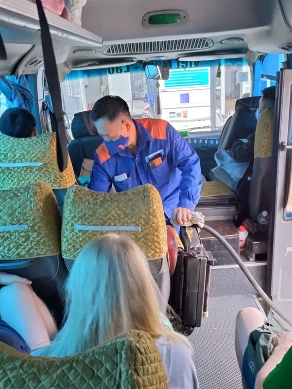 The bus being refilled with fuel through a front passenger seat